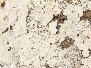 Background concrete wall, traces of weathering, worn wall damaged paint old paint. Remains of old paint on the painted concrete surface. Grungy concrete surface.