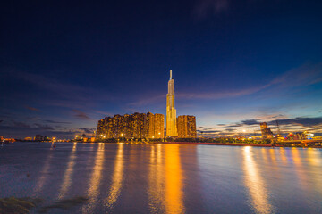 Sunset at Landmark 81 is a super tall skyscraper in center Ho Chi Minh City, Vietnam and Saigon bridge with development buildings, energy power infrastructure.