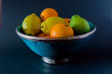 Bowl of fresh fruits, lemon, lime, orange.