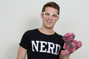 Portrait of happy young handsome nerd man