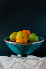 Bowl of fresh fruits, lemon, lime, orange.