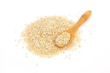 Sesame seeds in a wooden spoon isolated on white background top view.