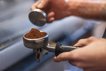 Barista with portafilter preparing coffee