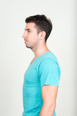 Obraz premium Portrait of young handsome Hispanic man against white background