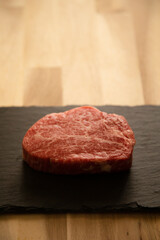 Fillet steak on the wooden round plate