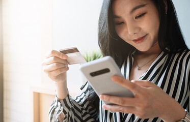 close up woman using smartphone and credit card for pay online shopping e-commerce online payment concept.