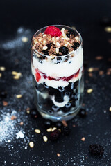 Ice cream, raspberry, currant and pine nuts in glass