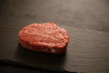Fillet steak on the wooden round plate