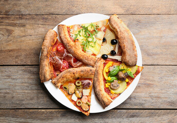 Slices of different pizzas on wooden table, top view
