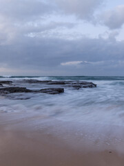 Wave water flow on a stormy day in the beach.