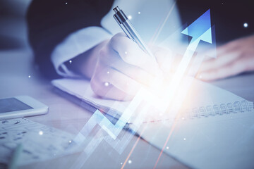 Blue arrow over woman's hands taking notes background. Concept of success. Double exposure