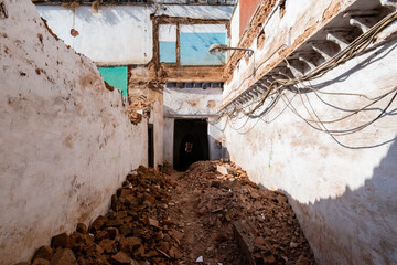 A demolished house with  rubble of brick and stone in India