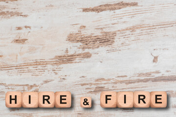 hire and fire printed on wooden cubes