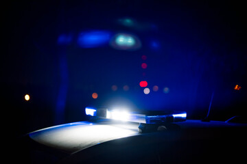 Police patrol car with blue sirens on