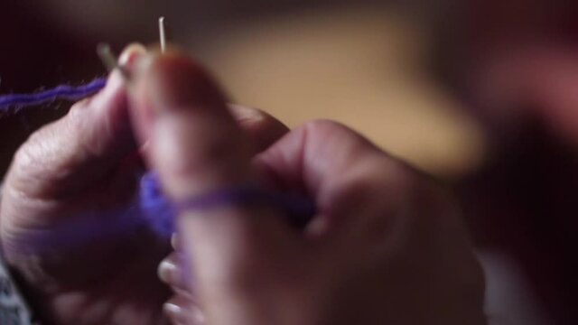 ederly woman hands Knitting doing crochet slow motion