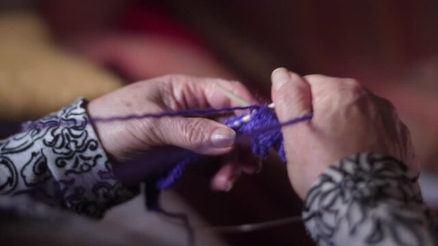 ederly woman hands Knitting doing crochet slow motion