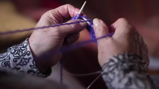 ederly woman hands Knitting doing crochet slow motion