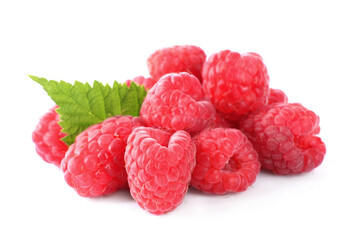 Pile of fresh ripe raspberries with leaves isolated on white
