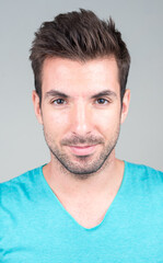 Obraz premium Portrait of young handsome Hispanic man against white background