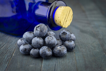 Fresh blueberries and corked pharmacy bottle