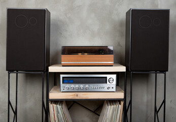 HiFi system with turntable, amplifier, headphones and lp vinyl records in a listening room