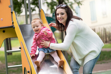 Fototapeta na wymiar Baby girl having fun on a playground