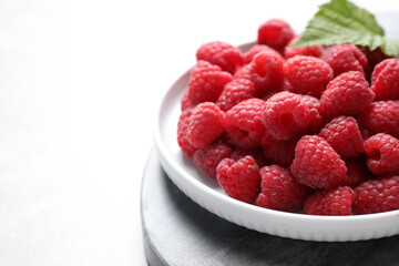 Delicious fresh ripe raspberries on white table, closeup