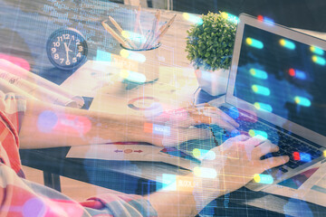 Double exposure of technology hologram with man working on computer background. Concept of big data.