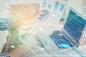 Multi exposure of technology hologram with man working on computer background. Concept of big data.