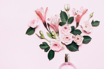 Floral arrangement with perfume bottle and pink flowers. Minimal beauty concept
