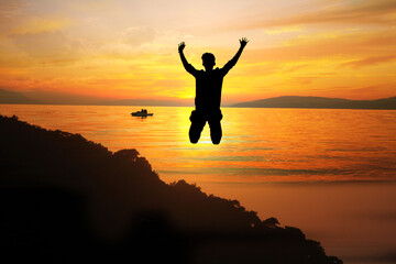 Fototapeta premium silhouette of man jumping on the beach