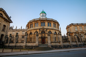 Fototapeta na wymiar The Sheldonian Theatre and the statues around it, from Broad Street in Oxford with no people. Early in the morning. Oxford, England, UK.