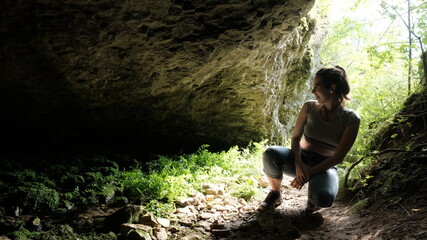 Fototapeta na wymiar A young woman exploring the cave