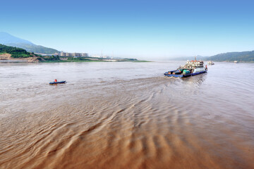 On the Yangtze River, cargo ships shuttle back and forth, and the 