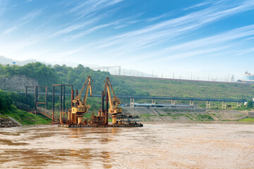 the yangtze river landscape in early morning, cargo crane on inland river wharf