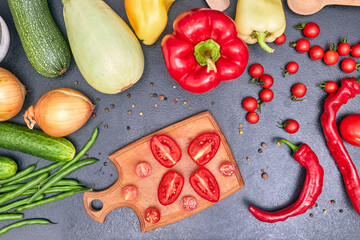 chopped tomato on a wooden board with vegetables flatlay