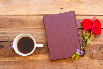 notebook planner for business work with hot coffee, red flowers hibiscus arrangement flat lay style on background wooden