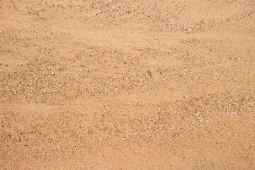 Background with sand texture. Sandy road. Texture of wet sand washed out by water. 