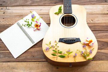 notebook planner and guitar of lifestyle woman relax summer and flowers frangipani ,purple flowers...