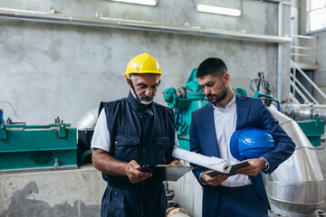 industry worker and businessman discussing in industry plant
