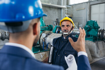 businessman manager yelling to a industry worker