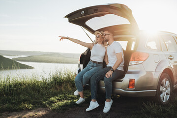 Man and Woman Relaxing Inside the Car Trunk Enjoying Weekend Road Trip, Travel and Adventure Concept