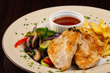 chicken fillet with vegetables and French fries
