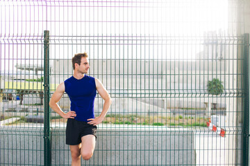 Half length portrait of handsome man with athletic body rest after workout exercise outdoors, young male runner taking break with copy space area for your text message or advertising content