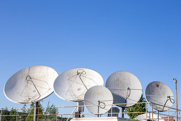 A group of dirty satellite dishes. Satellite dish&nbsp;is a dish-shaped type of parabolic antenna designed to receive or transmit information by radio waves to or from a communication satellite.