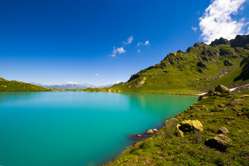 Fototapeta na wymiar Alpine mountain lake landscape and view, blue beautiful and amazing lake panorama