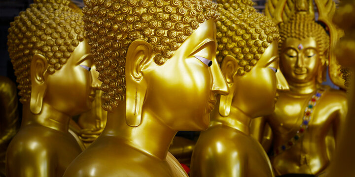close up of head of statue of buddha, in buddhist temple ,with golden color