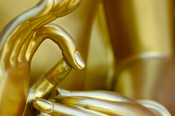 hand 's detail of   statue of buddha, in buddhist temple ,with golden color