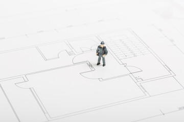 Building renovation drawings and miniature workers
