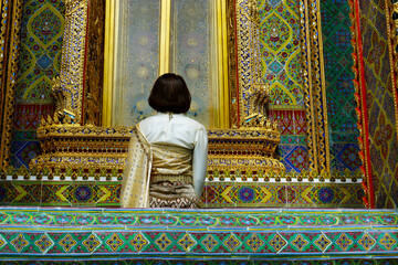 Fototapeta premium woman with traditional clothes in the buddhist temple rachabopit in the city of bangkok -thailand 